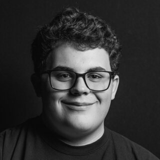 Skye Fugate, smiling, in a black and white studio portrait.